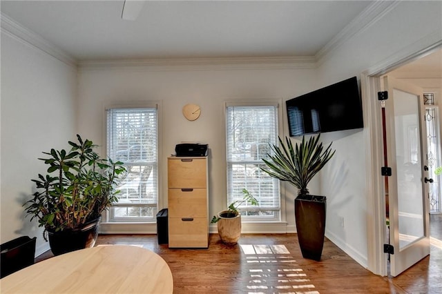 living area with french doors, crown molding, and hardwood / wood-style flooring