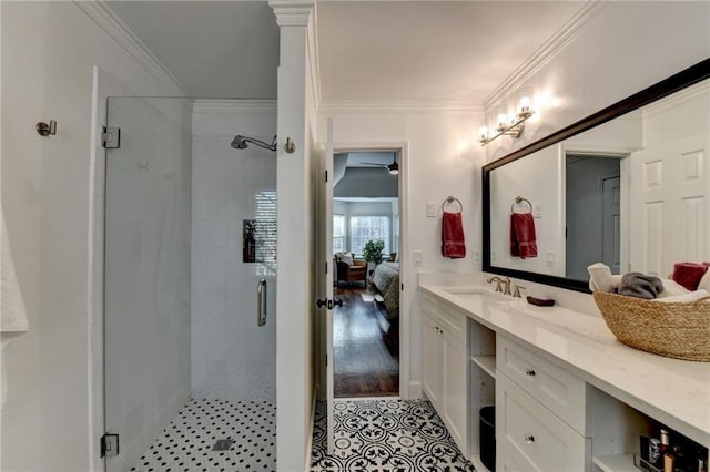 bathroom featuring vanity, tile patterned flooring, a shower with door, and crown molding