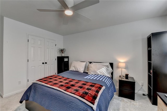 carpeted bedroom with ceiling fan and a closet