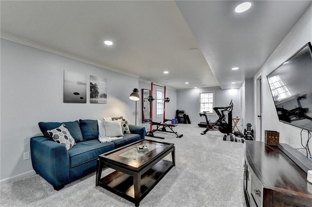 carpeted living room with ornamental molding