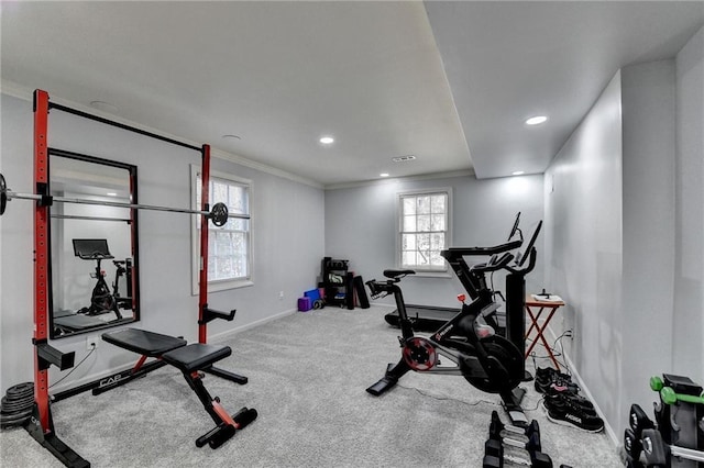 workout room featuring carpet and crown molding