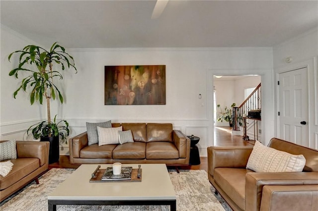 living room featuring ornamental molding and light wood-type flooring