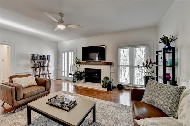 living room featuring ceiling fan, hardwood / wood-style floors, and french doors