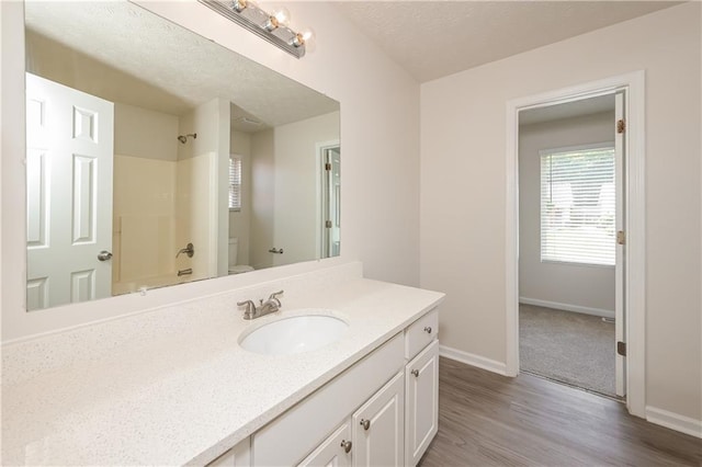 113 Garden Walk, Stockbridge, GA 30281 - full bath with vanity, wood finished floors,  shower combination, and a textured ceiling