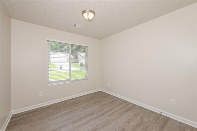 113 Garden Walk, Stockbridge, GA 30281 - empty room with light wood-style flooring and a textured ceiling
