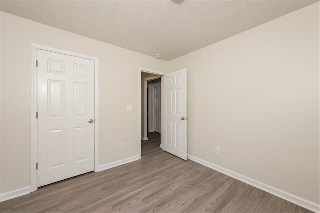 113 Garden Walk, Stockbridge, GA 30281 - unfurnished bedroom featuring light wood-style floors and a textured ceiling