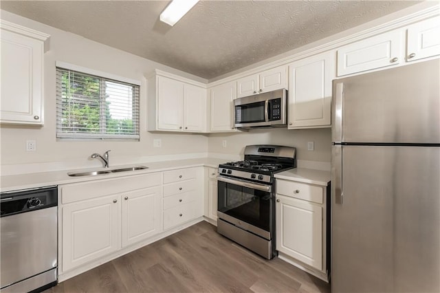 113 Garden Walk, Stockbridge, GA 30281 - kitchen with stainless steel appliances, dark wood-style flooring, white cabinetry, light countertops, and a textured ceiling