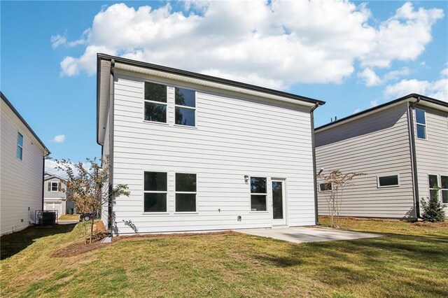 rear view of property featuring cooling unit, a yard, and a patio area