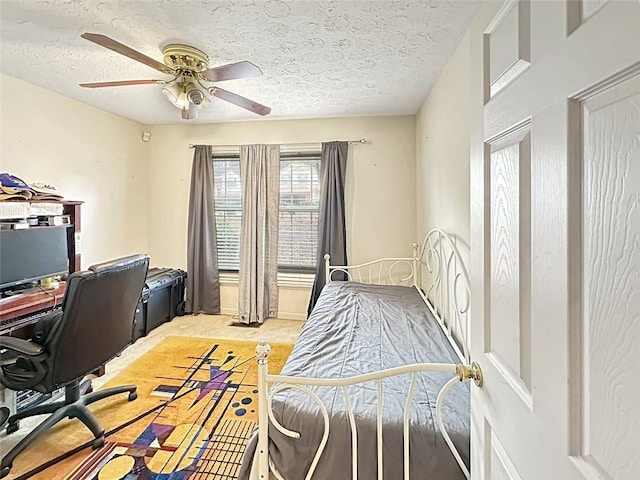 home office featuring ceiling fan, carpet, and a textured ceiling