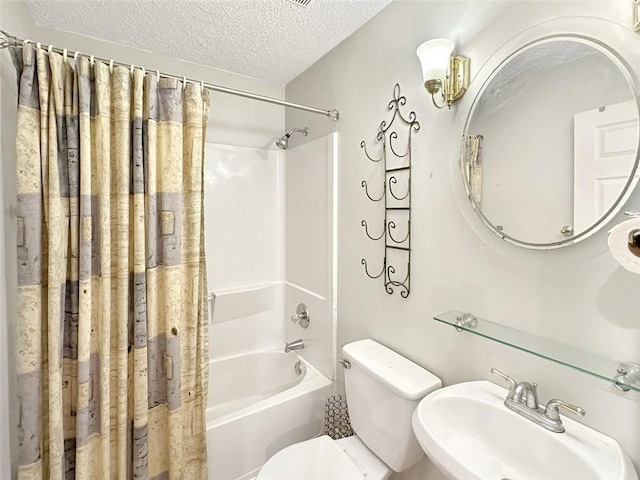 full bathroom featuring shower / tub combo, a textured ceiling, toilet, and sink