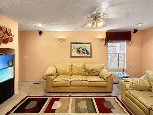 unfurnished living room featuring ceiling fan, a textured ceiling, and light carpet