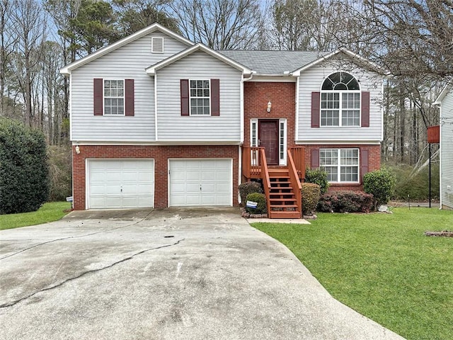 raised ranch featuring a garage and a front lawn