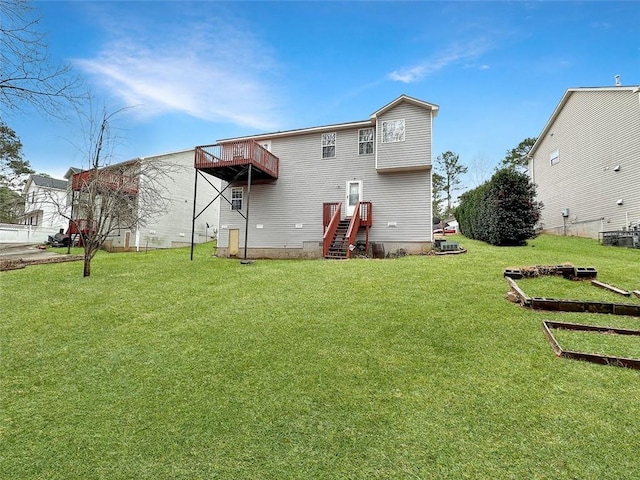 rear view of property with a balcony and a lawn