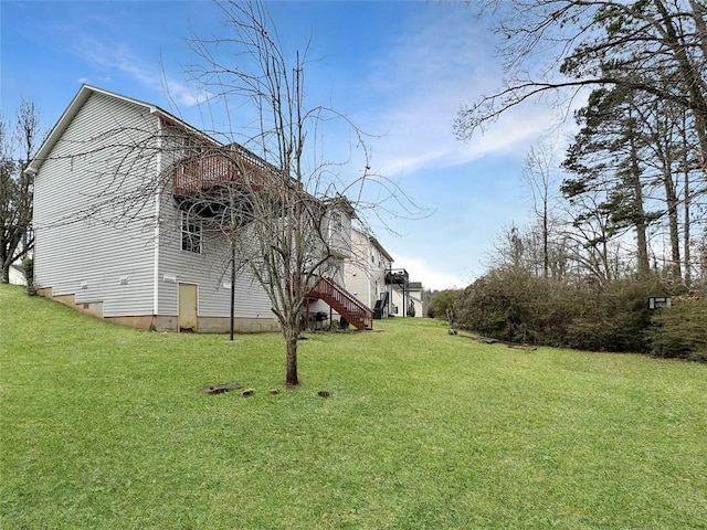 view of side of home with a yard