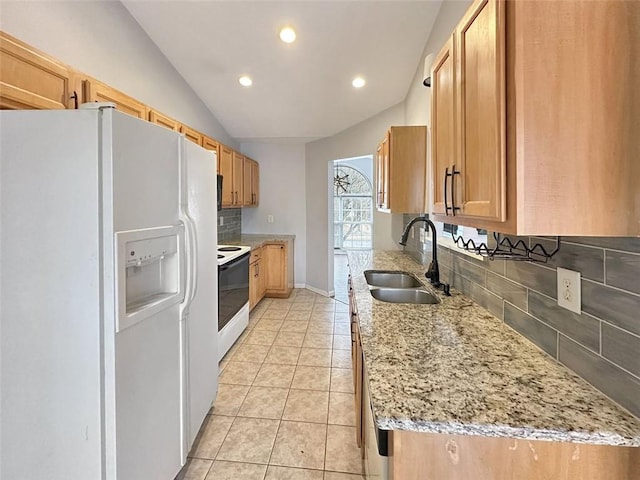 kitchen with light stone countertops, sink, lofted ceiling, white appliances, and decorative backsplash