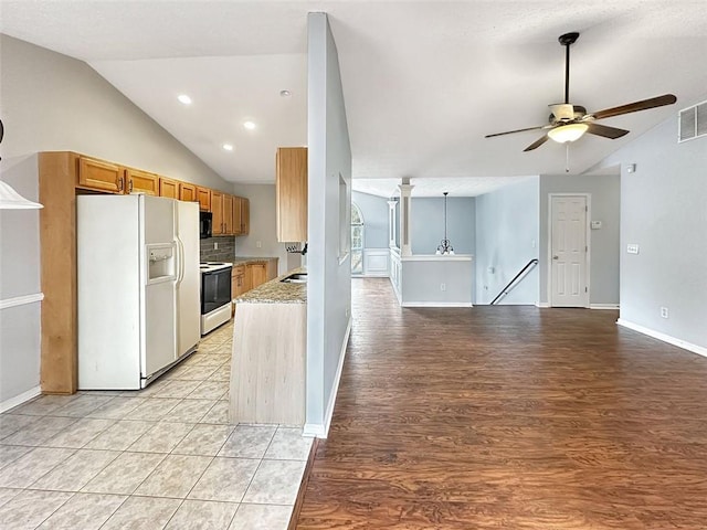 kitchen with ceiling fan, light stone countertops, tasteful backsplash, lofted ceiling, and white appliances