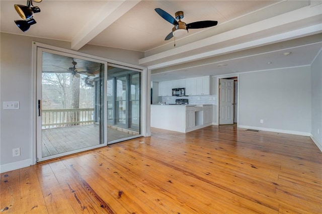 unfurnished living room with ceiling fan, light wood-type flooring, and lofted ceiling with beams