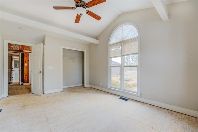 unfurnished bedroom with vaulted ceiling, ceiling fan, and a closet