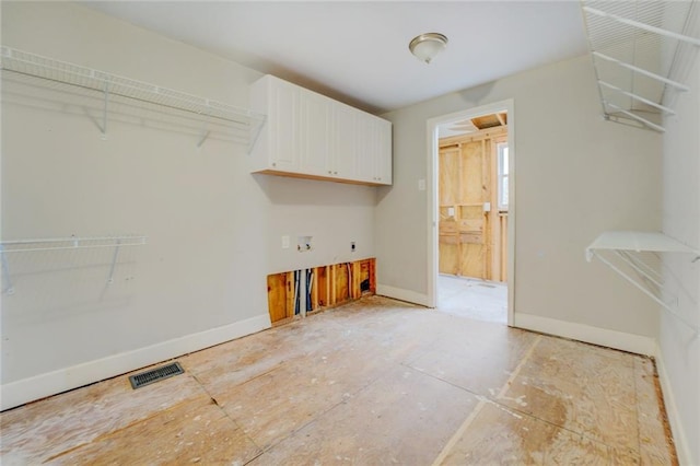 clothes washing area featuring cabinets, hookup for an electric dryer, and washer hookup