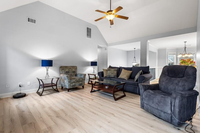 living room featuring ceiling fan with notable chandelier, light wood-type flooring, and high vaulted ceiling