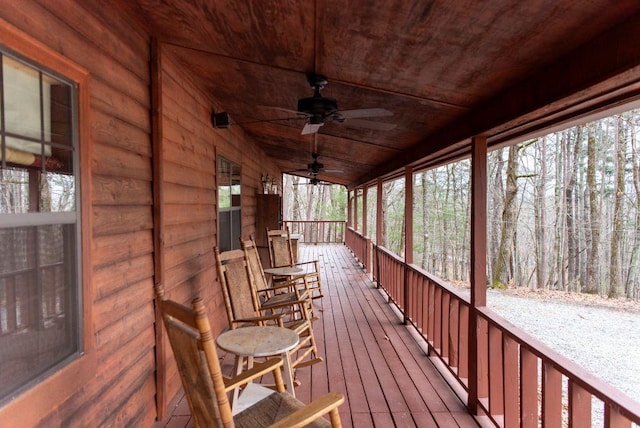 wooden terrace featuring ceiling fan and a porch