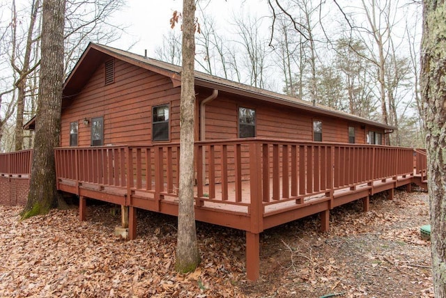 rear view of house with a wooden deck