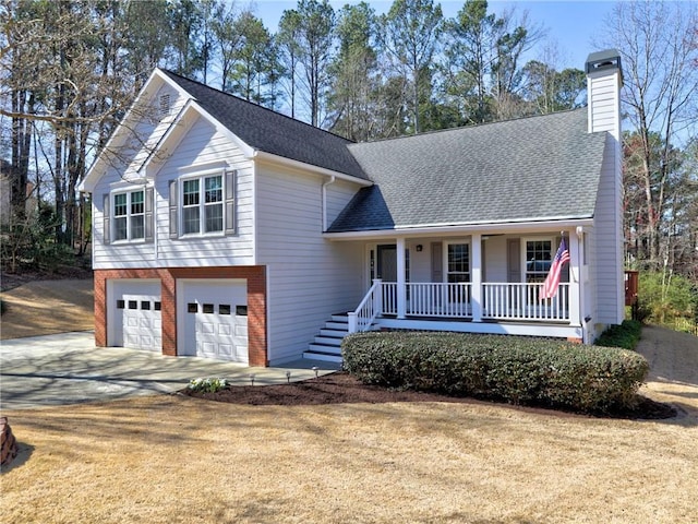 split level home with a chimney, a porch, concrete driveway, and a shingled roof