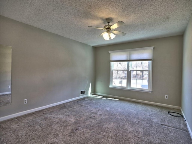 empty room featuring visible vents, baseboards, carpet, and a ceiling fan