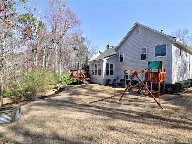 rear view of house featuring a wooden deck