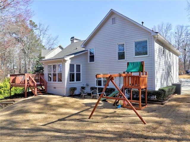 back of house with a wooden deck, central AC, a shingled roof, crawl space, and a playground