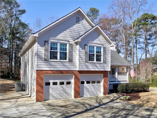 view of front facade featuring concrete driveway, an attached garage, central AC unit, and brick siding