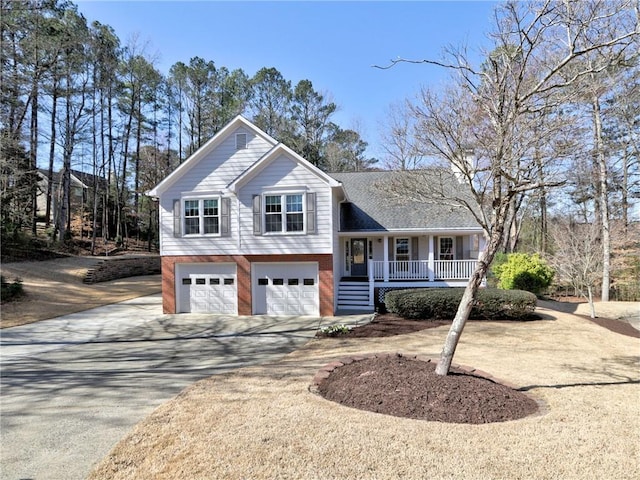 tri-level home with a garage, brick siding, covered porch, and concrete driveway