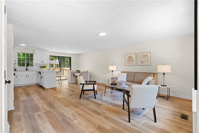 1275 Muirforest Way, Stone Mountain, GA 30088 - living area featuring light wood-style flooring, recessed lighting, and baseboards