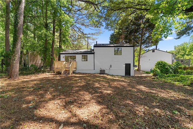 1275 Muirforest Way, Stone Mountain, GA 30088 - rear view of house featuring a wooden deck and central AC