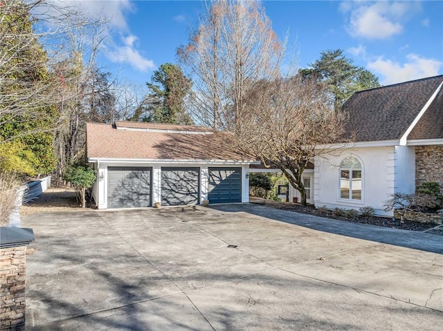 view of front of house featuring a shingled roof and stucco siding