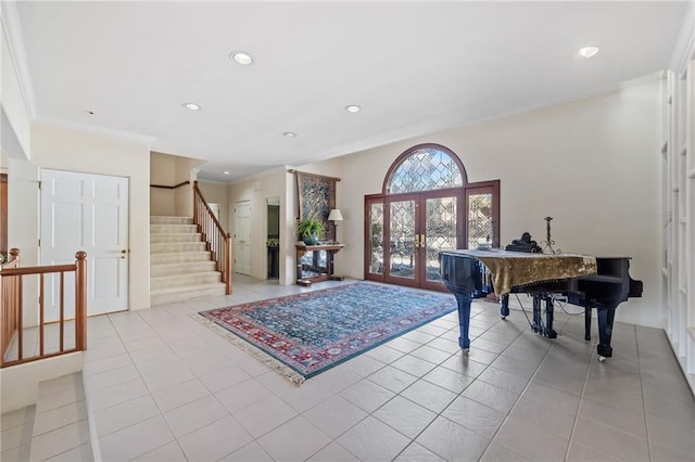 entryway with stairs, french doors, light tile patterned flooring, and ornamental molding