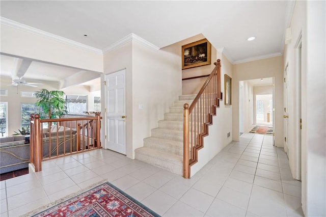 stairs with beamed ceiling, tile patterned flooring, a ceiling fan, and crown molding