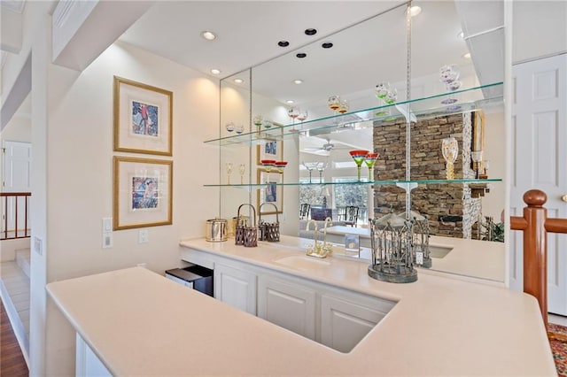 bar with a ceiling fan, a sink, and recessed lighting