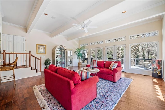 living area featuring hardwood / wood-style floors, french doors, beamed ceiling, and a wealth of natural light