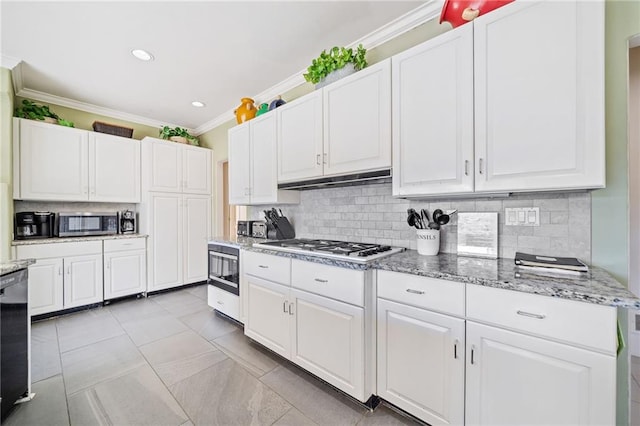 kitchen featuring light stone counters, stainless steel appliances, white cabinets, tasteful backsplash, and crown molding