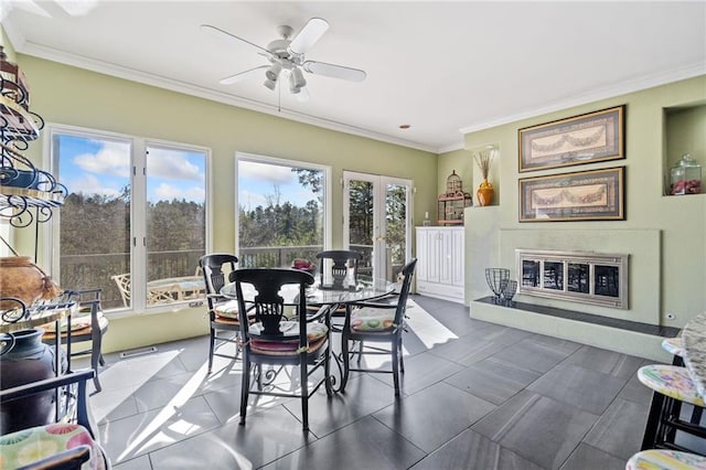 dining room featuring crown molding, french doors, a ceiling fan, and a healthy amount of sunlight