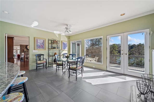 sunroom featuring french doors, plenty of natural light, and a ceiling fan