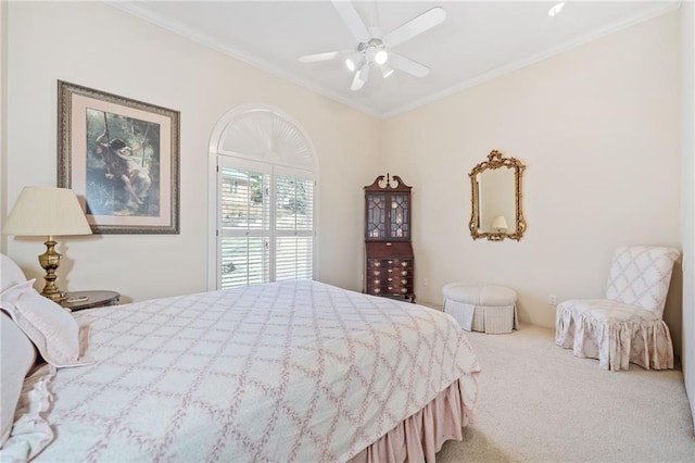 carpeted bedroom with ceiling fan and crown molding