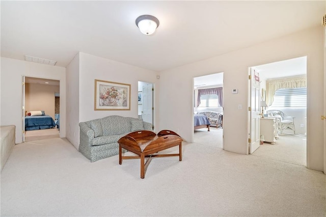 sitting room featuring carpet, visible vents, and a healthy amount of sunlight