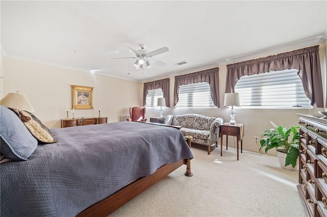 bedroom with carpet floors, visible vents, crown molding, and a ceiling fan