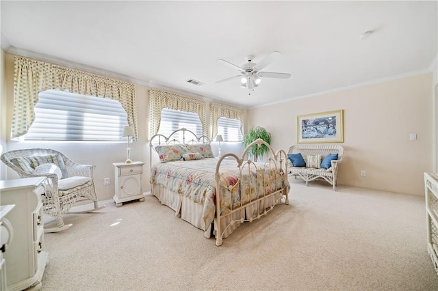 bedroom featuring a ceiling fan, carpet, visible vents, and crown molding