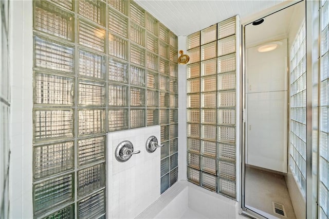 bathroom featuring visible vents and tiled shower