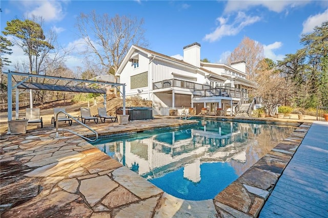 outdoor pool featuring a patio area, a jacuzzi, stairs, and a pergola