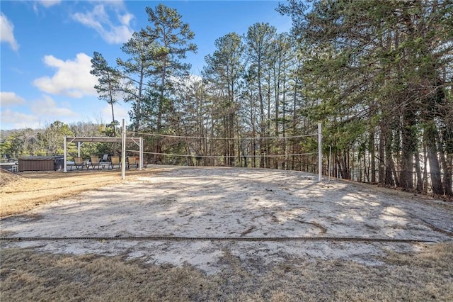 view of home's community featuring a jacuzzi and volleyball court