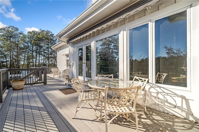 deck with outdoor dining space and french doors